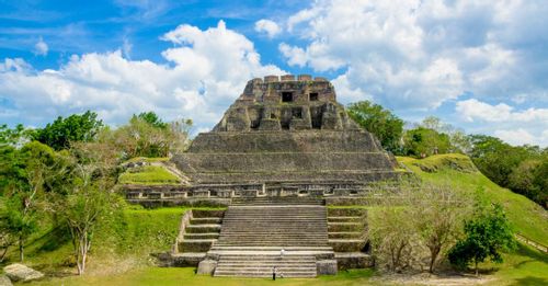 Climb to the top of El Castillo at Xunantunich for panoramic views and Guatemala in the distance