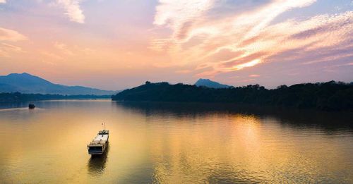 Admire the scenic Laos landscape on a Mekong River Cruise