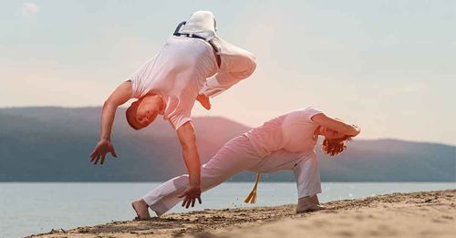 Practice the rhythmic movements of Capoeira
