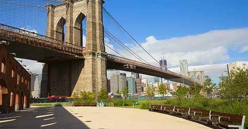 See the city from the Brooklyn Bridge Park